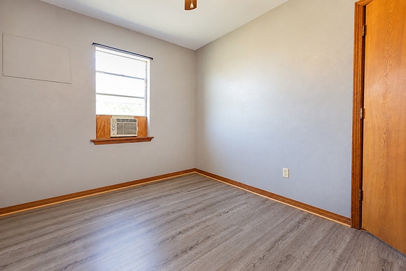 Empty Gray Bedroom with Window AC re